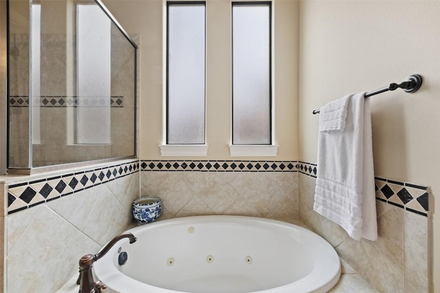 2328 Gilia Dr, Austin, TX 78733 - bathroom featuring a whirlpool tub, tile walls, and a wainscoted wall