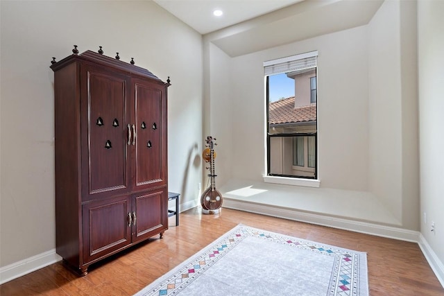 foyer entrance with light wood-type flooring, baseboards, and recessed lighting