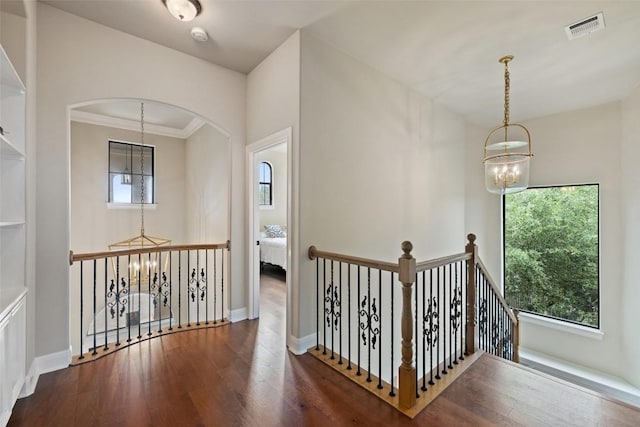 2328 Gilia Dr, Austin, TX 78733 - hallway with a chandelier, plenty of natural light, wood finished floors, an upstairs landing, and ornamental molding