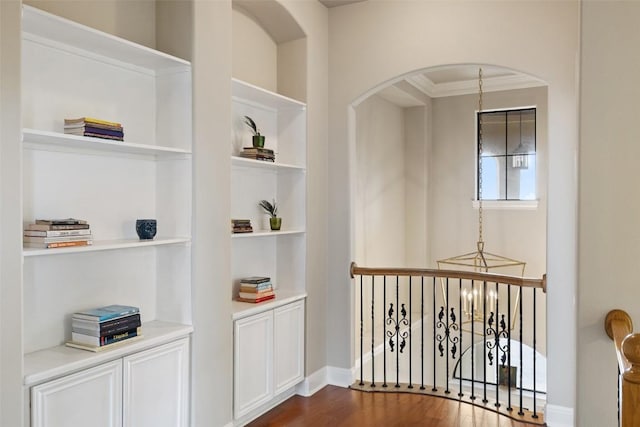 2328 Gilia Dr, Austin, TX 78733 - corridor with built in features, dark wood-style flooring, crown molding, and arched walkways