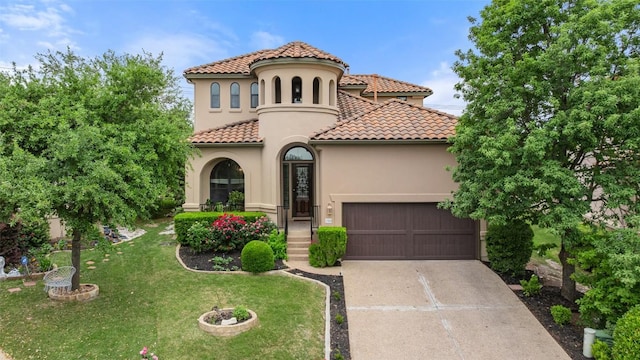 mediterranean / spanish-style home featuring a tile roof, concrete driveway, a front yard, a garage, and stucco siding