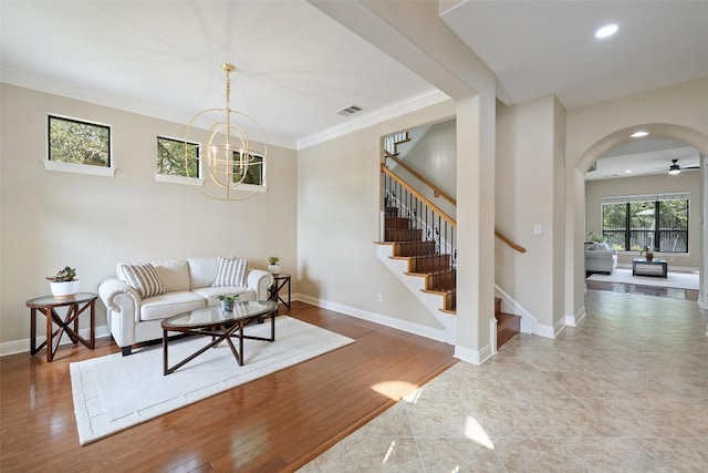 living area with recessed lighting, stairway, visible vents, ornamental molding, and arched walkways