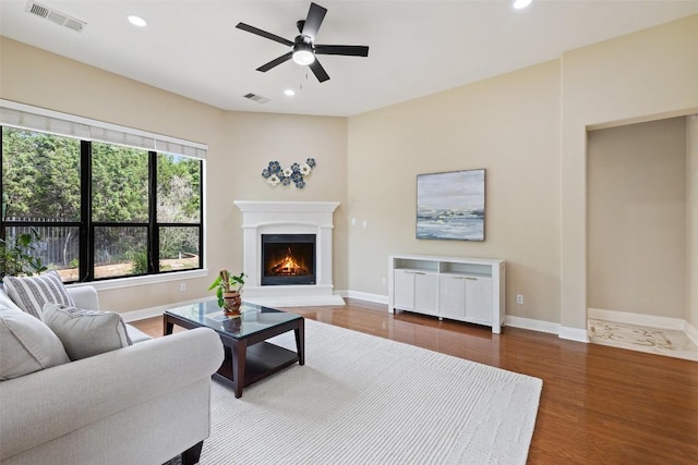 2328 Gilia Dr, Austin, TX 78733 - living area featuring wood finished floors, recessed lighting, ceiling fan, and a lit fireplace