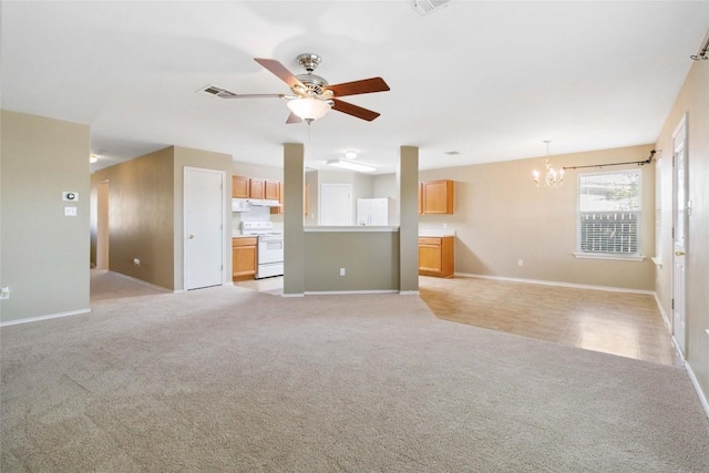223 Sylvan St, Hutto, TX 78634 - unfurnished living room featuring light carpet, ceiling fan with notable chandelier, visible vents, and baseboards