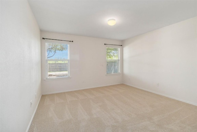 223 Sylvan St, Hutto, TX 78634 - empty room featuring baseboards and light colored carpet