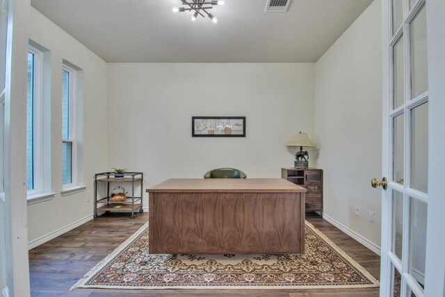 office with dark wood finished floors, plenty of natural light, visible vents, and baseboards