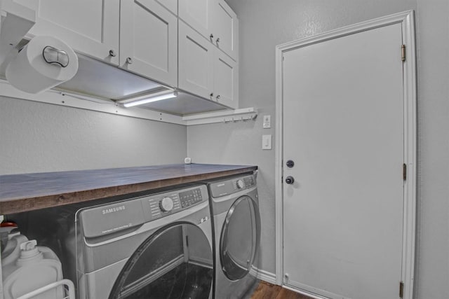 washroom featuring dark wood finished floors, separate washer and dryer, cabinet space, and a textured wall