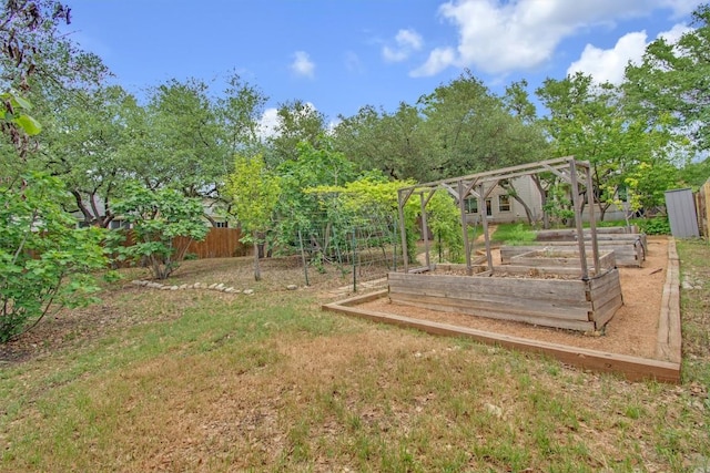 view of yard with a garden and fence