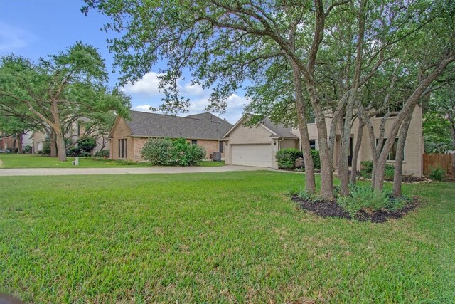 view of front of property with a garage, driveway, a front yard, and fence