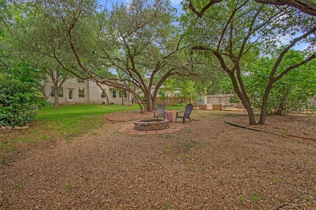 view of yard featuring fence and a fire pit