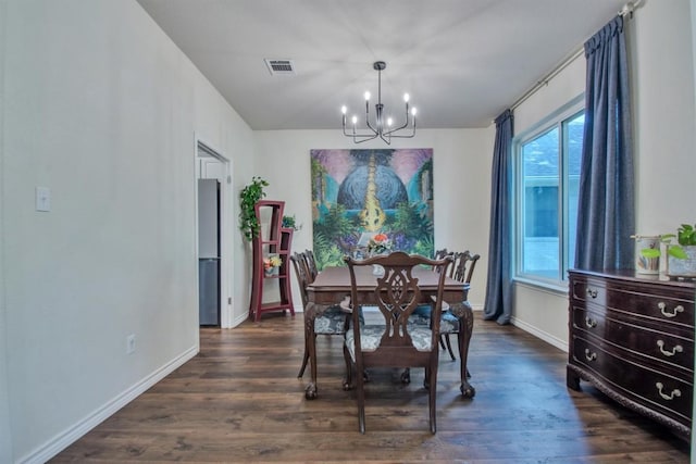 dining room with a chandelier, visible vents, baseboards, and dark wood-style floors