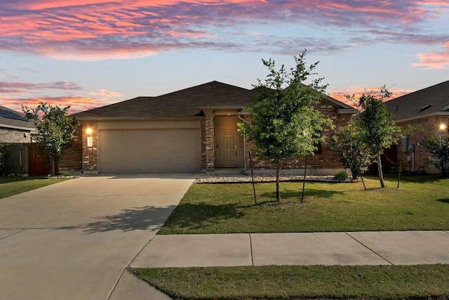 view of front of home with brick siding, an attached garage, driveway, and a yard