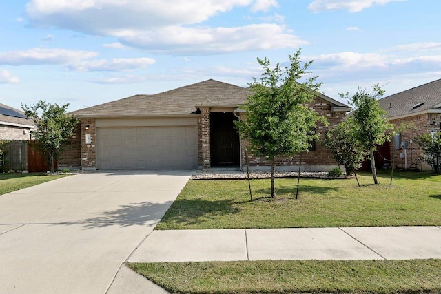 ranch-style house featuring brick siding, an attached garage, a front yard, and concrete driveway