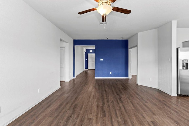 unfurnished room featuring ceiling fan, baseboards, dark wood-style flooring, and visible vents