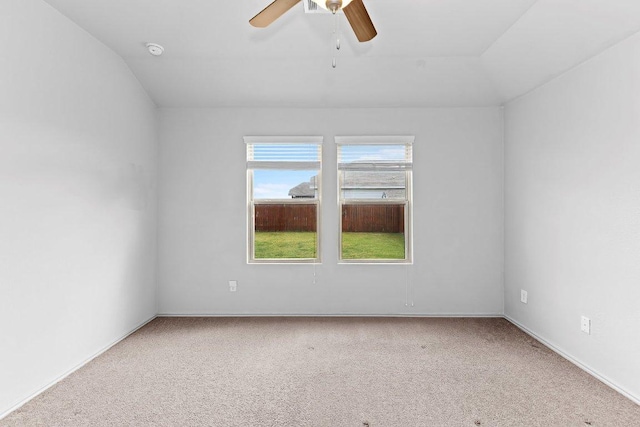 unfurnished room with vaulted ceiling, carpet, and a ceiling fan