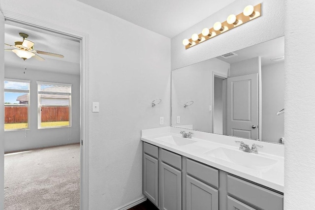 full bathroom with double vanity, visible vents, ceiling fan, and a sink