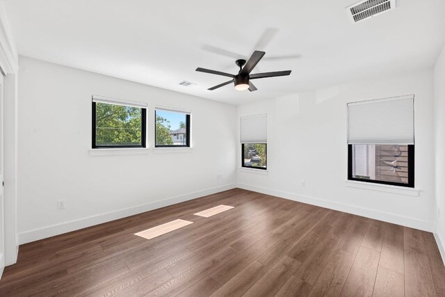 7008 Meador Ave Unit 1, Austin, TX 78752 - unfurnished room with dark wood-style floors, baseboards, and a ceiling fan