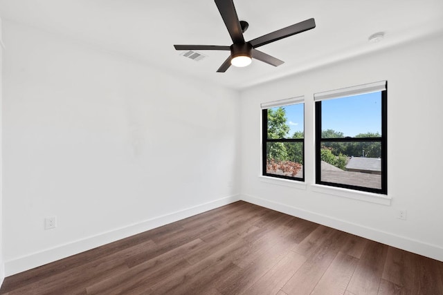 7008 Meador Ave Unit 1, Austin, TX 78752 - unfurnished room featuring ceiling fan, baseboards, dark wood-style flooring, and visible vents
