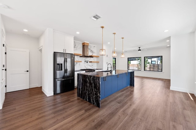 7008 Meador Ave Unit 1, Austin, TX 78752 - kitchen featuring stainless steel fridge, wall chimney exhaust hood, a sink, dark wood-style floors, and ceiling fan