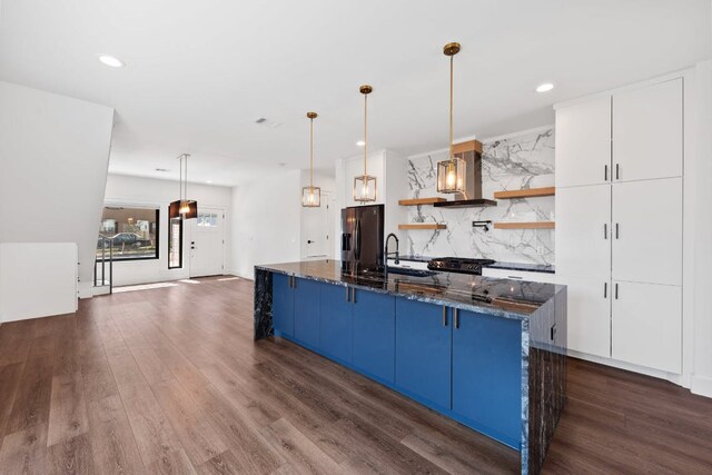 7008 Meador Ave Unit 1, Austin, TX 78752 - kitchen with refrigerator with ice dispenser, a sink, open shelves, a kitchen breakfast bar, and blue cabinetry