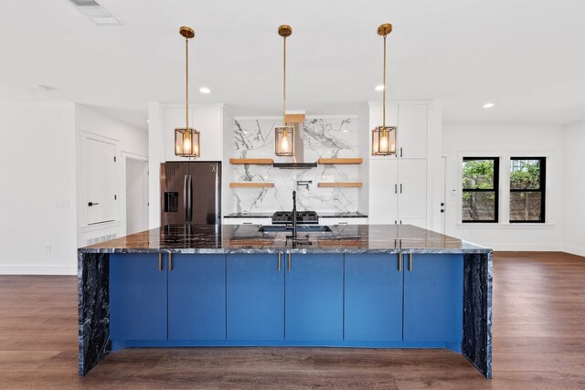 7008 Meador Ave Unit 1, Austin, TX 78752 - kitchen featuring stainless steel fridge with ice dispenser, open shelves, backsplash, dark stone countertops, and dark wood finished floors