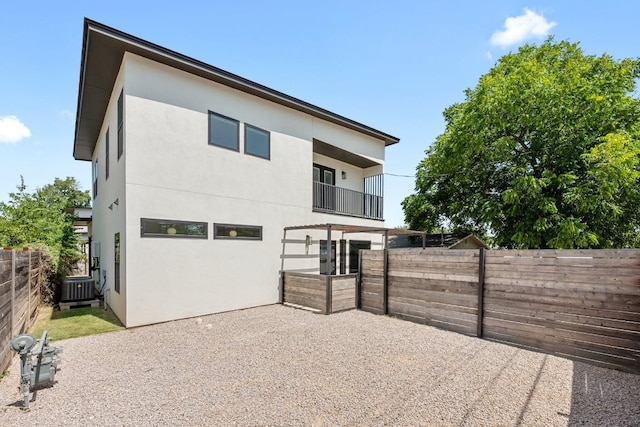7008 Meador Ave Unit 1, Austin, TX 78752 - back of house featuring stucco siding, a patio, and a fenced backyard