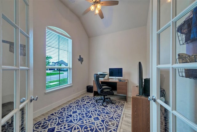 office space featuring lofted ceiling, french doors, light wood-type flooring, and a ceiling fan