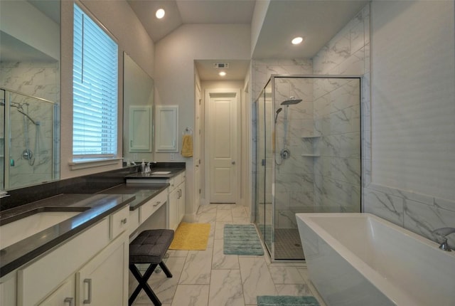 full bath featuring a shower stall, a freestanding bath, marble finish floor, and a sink