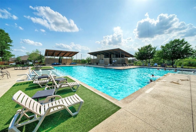 pool with fence and a patio