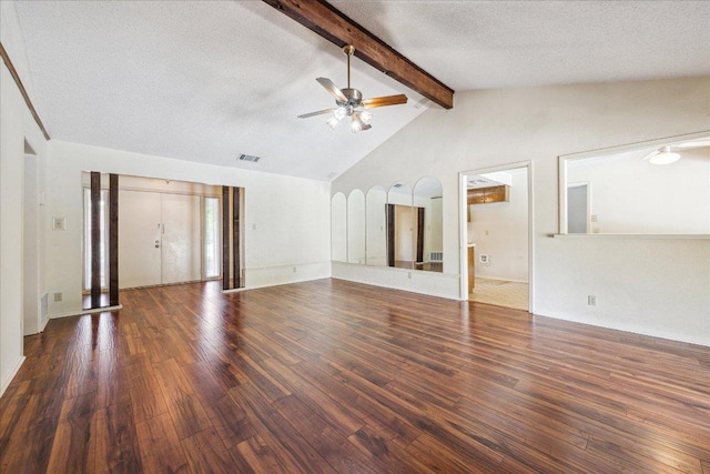 unfurnished living room featuring beamed ceiling, a ceiling fan, visible vents, a textured ceiling, and wood finished floors