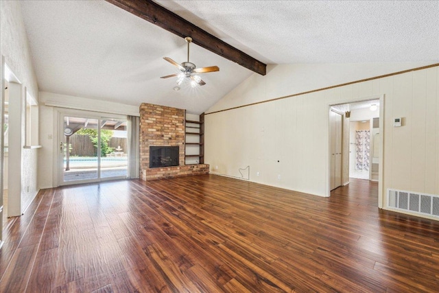 unfurnished living room featuring dark wood-style flooring, a fireplace, lofted ceiling with beams, a ceiling fan, and visible vents