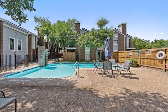 view of pool with fence and a patio area