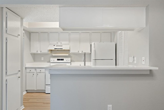 kitchen featuring white cabinetry, white appliances, under cabinet range hood, and light wood finished floors