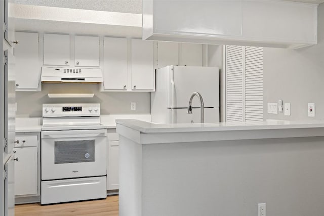 kitchen with a sink, under cabinet range hood, white appliances, light wood-type flooring, and light countertops