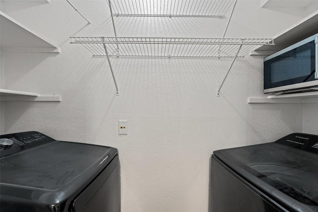 washroom with separate washer and dryer and laundry area