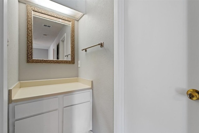 bathroom with visible vents and vanity