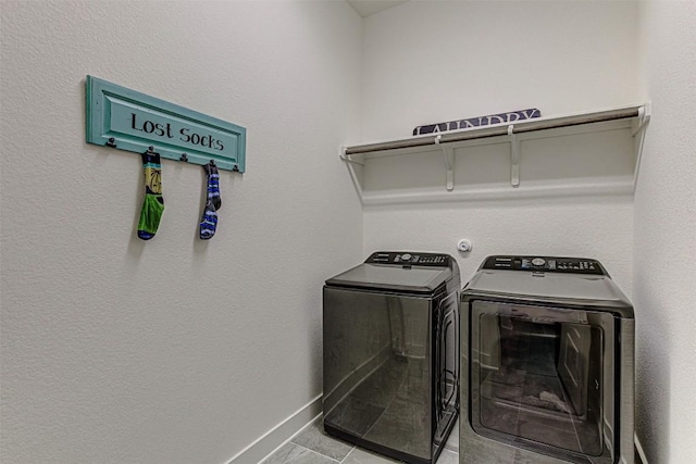 1801 Lakeside Ranch Rd, Georgetown, TX 78633 - laundry room with washer and clothes dryer, tile patterned flooring, and baseboards