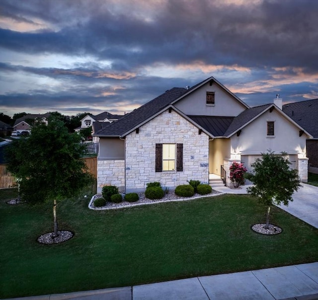 1801 Lakeside Ranch Rd, Georgetown, TX 78633 - view of front facade featuring stucco siding, a yard, and a standing seam roof