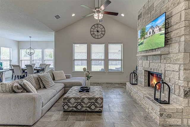 1801 Lakeside Ranch Rd, Georgetown, TX 78633 - living area with stone tile floors, ceiling fan, a stone fireplace, baseboards, and recessed lighting