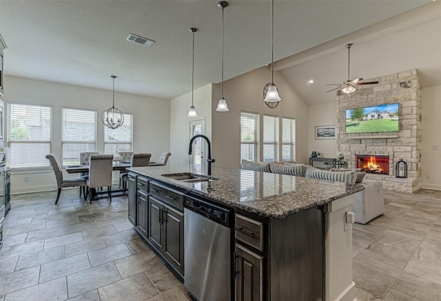 1801 Lakeside Ranch Rd, Georgetown, TX 78633 - kitchen featuring dishwasher, a sink, ceiling fan, baseboards, and a fireplace