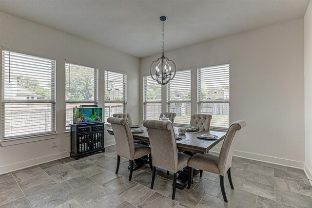 1801 Lakeside Ranch Rd, Georgetown, TX 78633 - dining space featuring baseboards, a chandelier, and light stone finish flooring