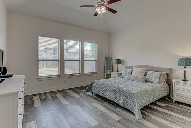 1801 Lakeside Ranch Rd, Georgetown, TX 78633 - bedroom with wood finished floors, lofted ceiling, baseboards, and a ceiling fan