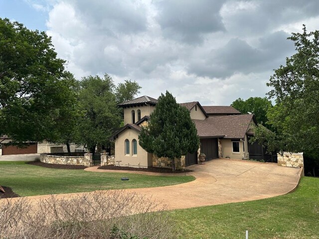 2749 Springwood Ln, Georgetown, TX 78628 - rear view of house featuring a lawn, concrete driveway, and an attached garage