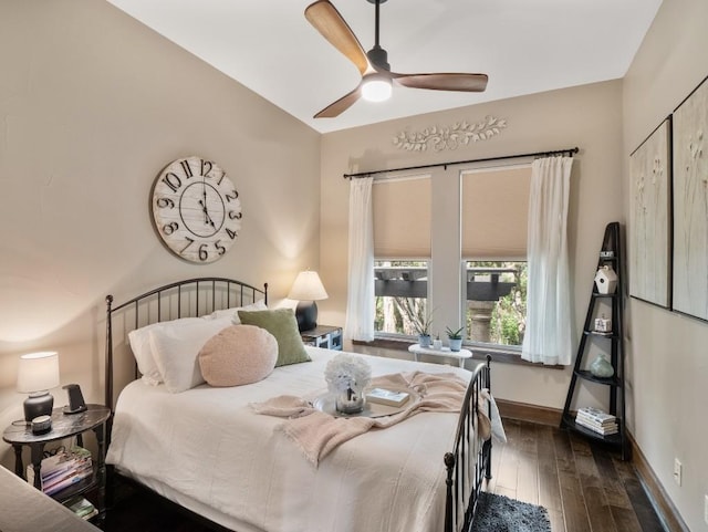 bedroom featuring ceiling fan, hardwood / wood-style flooring, and baseboards