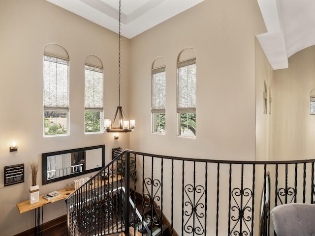 2749 Springwood Ln, Georgetown, TX 78628 - hallway with plenty of natural light, an upstairs landing, and a chandelier