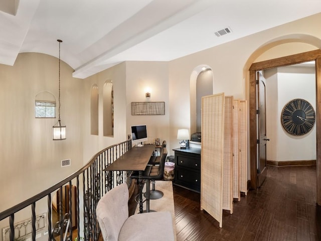 office featuring baseboards, visible vents, dark wood-type flooring, and vaulted ceiling