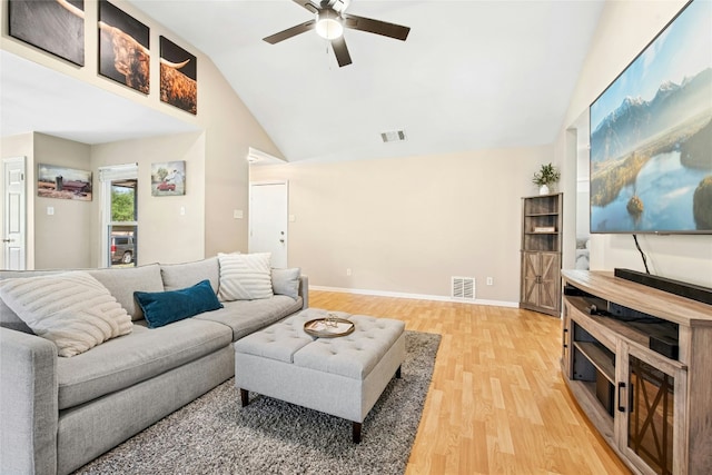 living area featuring visible vents, light wood-type flooring, ceiling fan, and high vaulted ceiling
