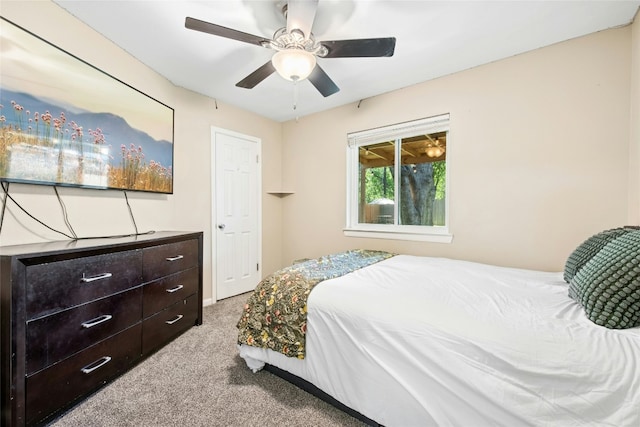 bedroom with ceiling fan and light carpet