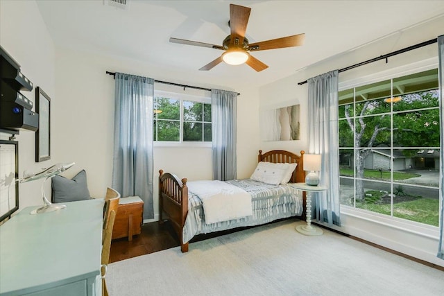 bedroom featuring baseboards, a ceiling fan, and wood finished floors