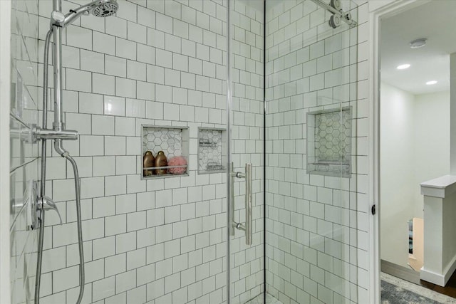 bathroom featuring a shower stall, baseboards, and recessed lighting